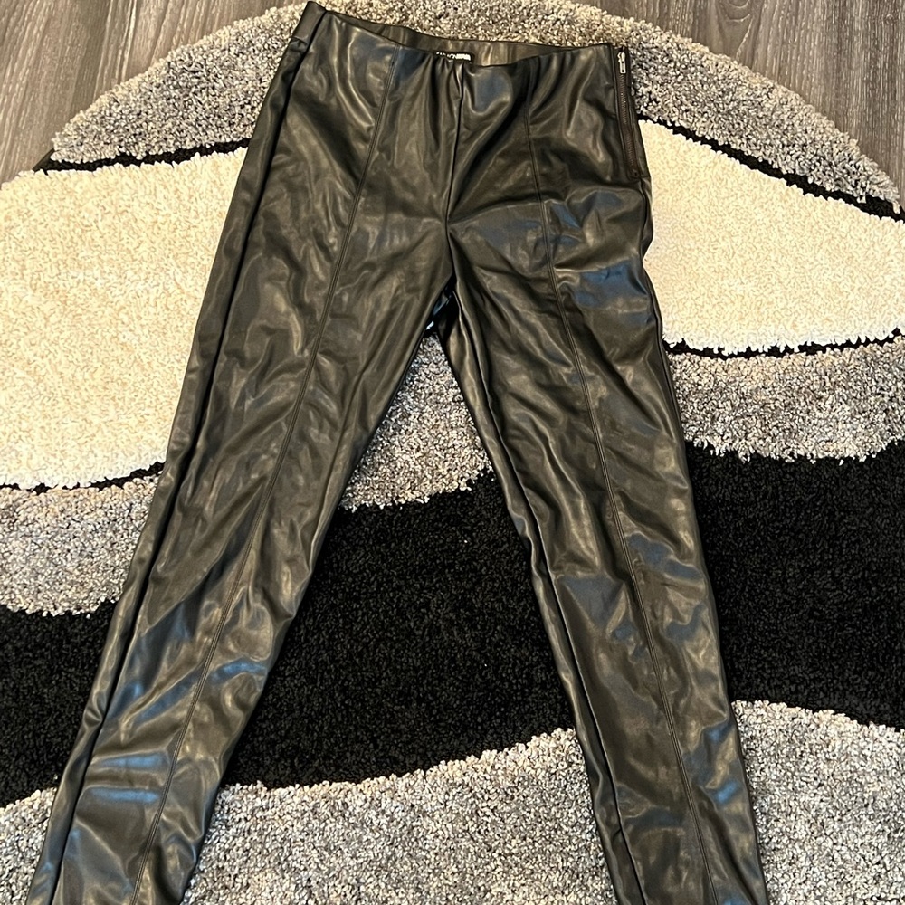 Black pleather pants. Zip and button side. Pleated down the front. Skinny leg.